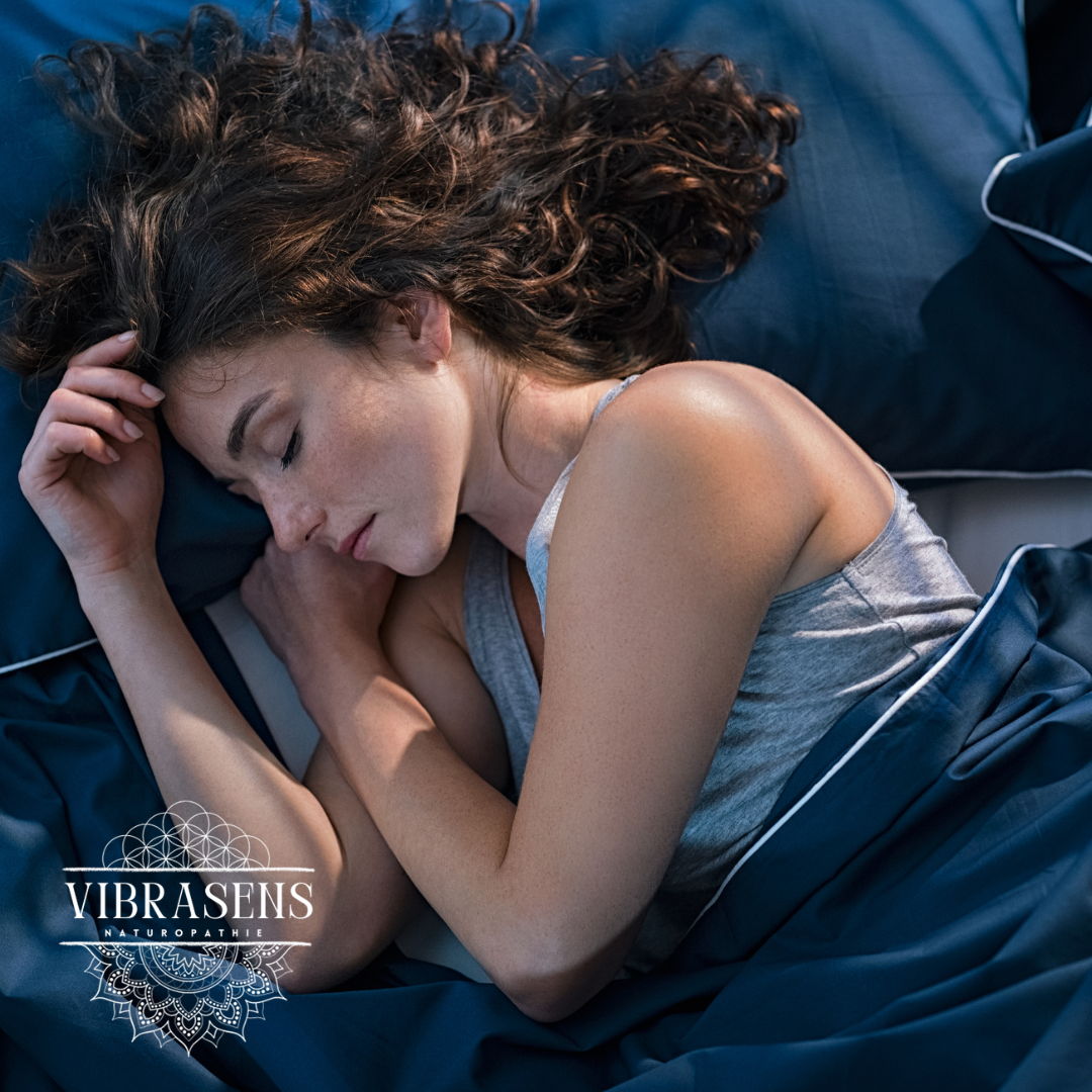 Woman peacefully sleeping on blue bedding, promoting restful sleep and emotional balance